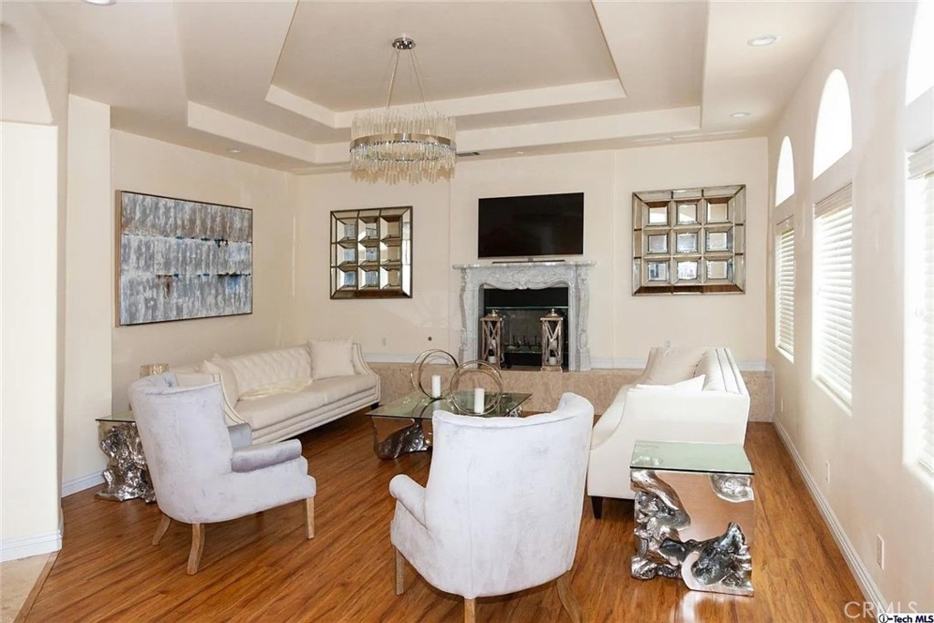 10062 Valley Cir Boulevard Chatsworth, CA 91311 - Photo 16 of 35 a living room with furniture a flat screen tv and a fireplace