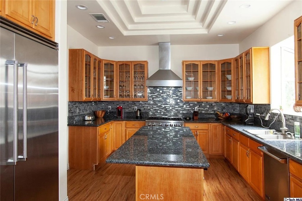 10062 Valley Cir Boulevard Chatsworth, CA 91311 - Photo 19 of 35 a kitchen with sink a refrigerator and wooden cabinets