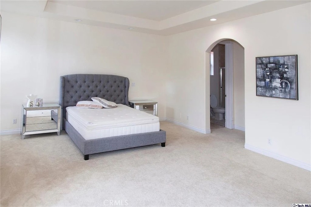 10062 Valley Cir Boulevard Chatsworth, CA 91311 - Photo 25 of 35 a bedroom with a bed and a couch