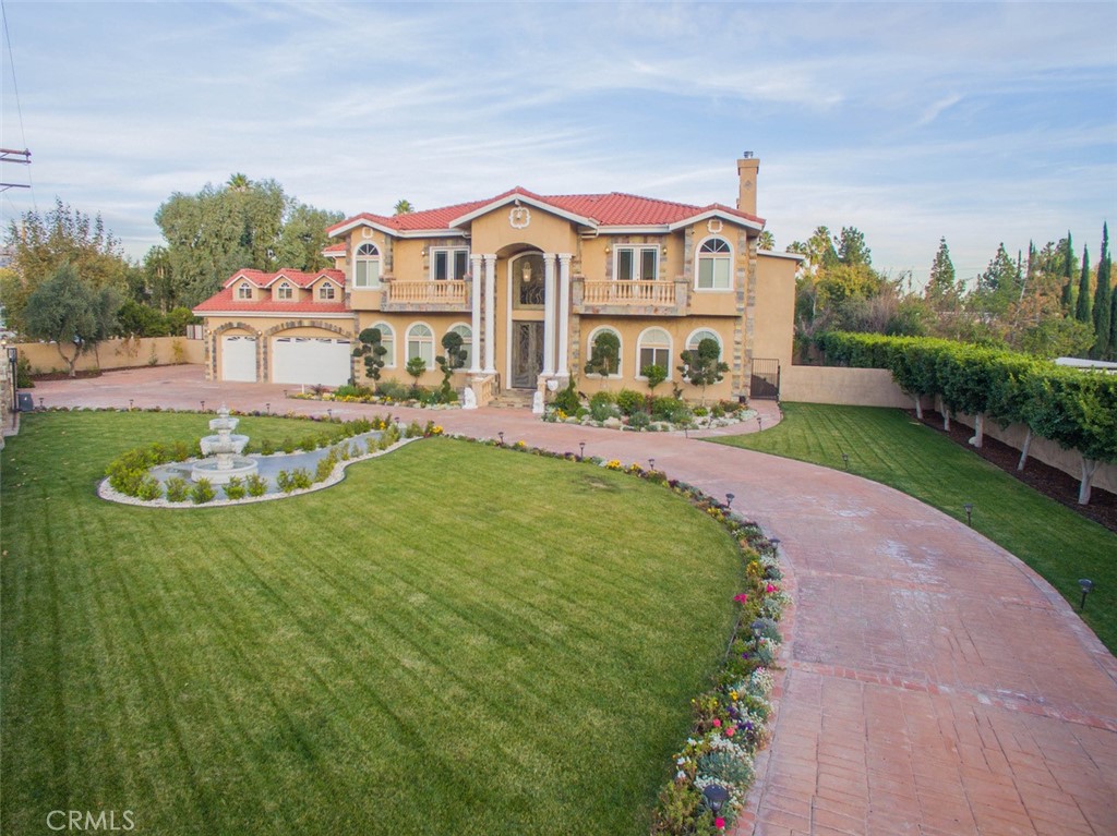 10062 Valley Cir Boulevard Chatsworth, CA 91311 - Photo 34 of 35 a view of a white house with a yard table and chairs