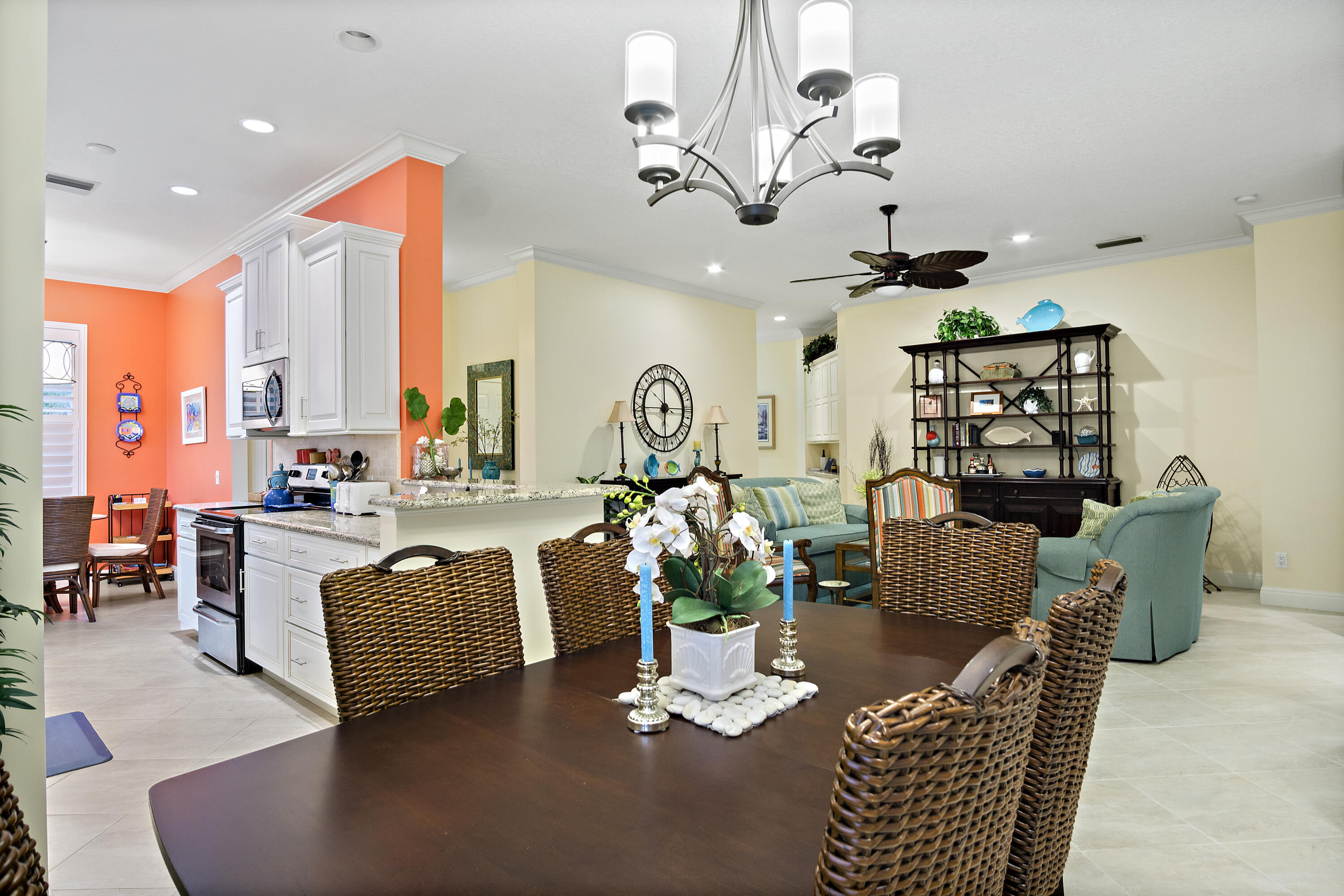 5058 Southeast Inkwood Way Hobe Sound, FL 33455 - Photo 9 of 36 a living room with furniture a chandelier and a dining table