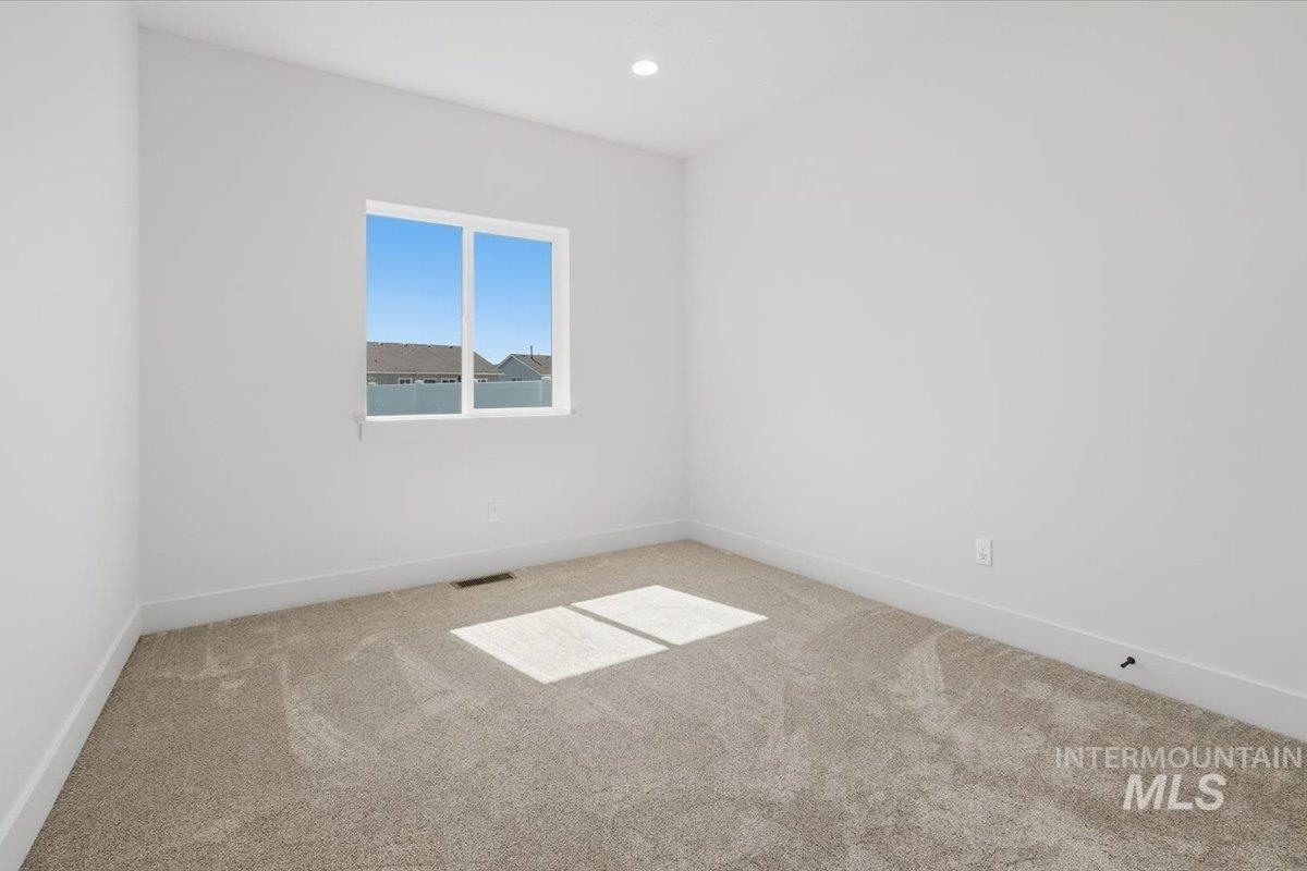 2173 Austin Way Fruitland, ID 83619 - Photo 9 of 28 Unfurnished room featuring light colored carpet and recessed lighting
