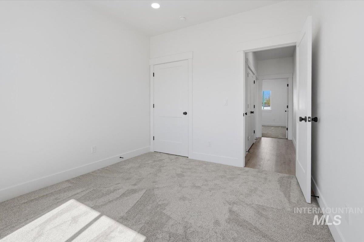 2173 Austin Way Fruitland, ID 83619 - Photo 10 of 28 Unfurnished bedroom with light colored carpet and baseboards