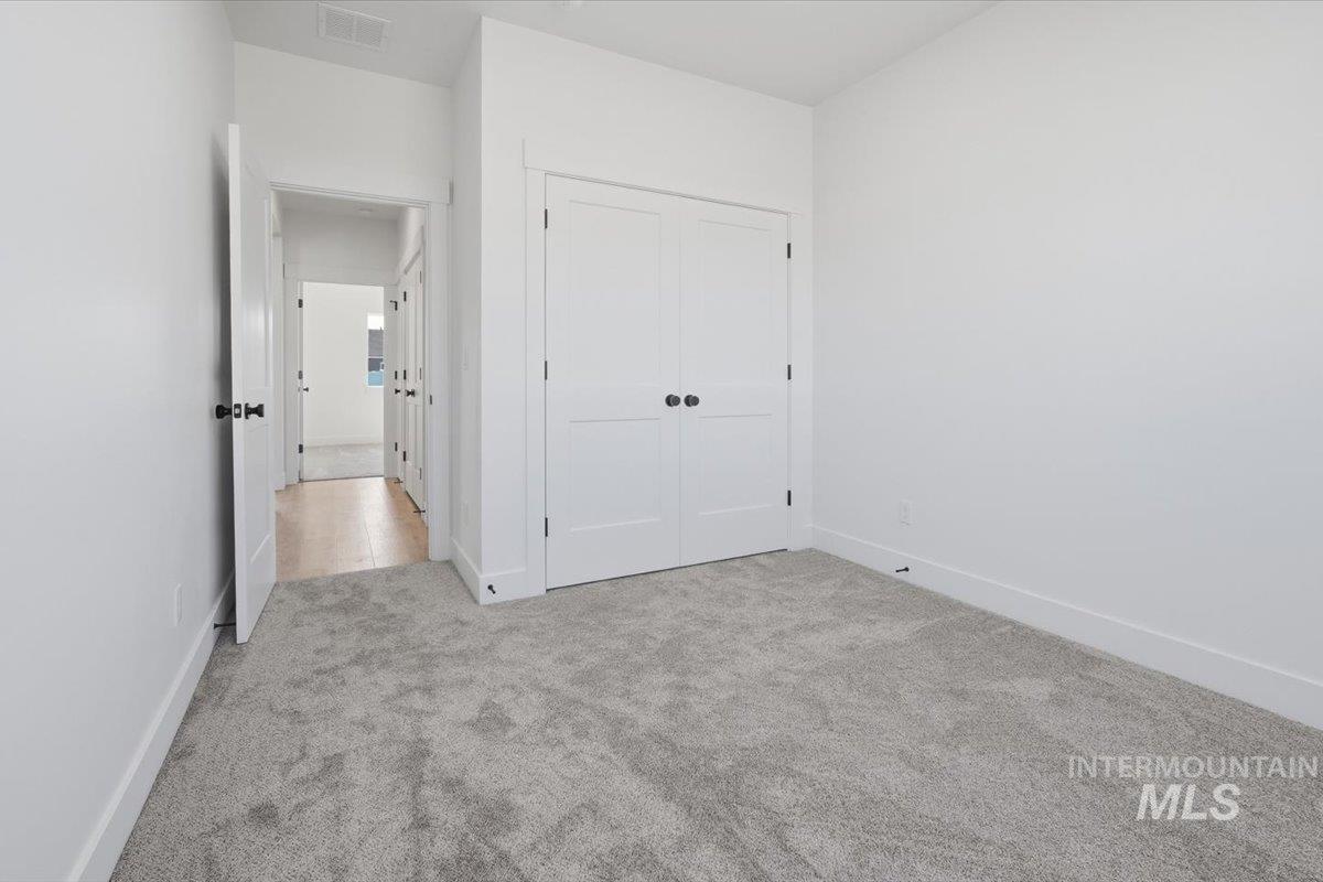 2173 Austin Way Fruitland, ID 83619 - Photo 12 of 28 Unfurnished bedroom with light colored carpet and a closet