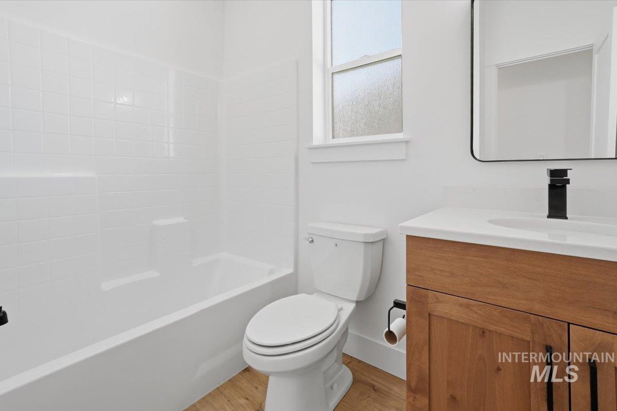 2173 Austin Way Fruitland, ID 83619 - Photo 13 of 28 Bathroom with vanity, bathtub / shower combination, and light wood-style floors