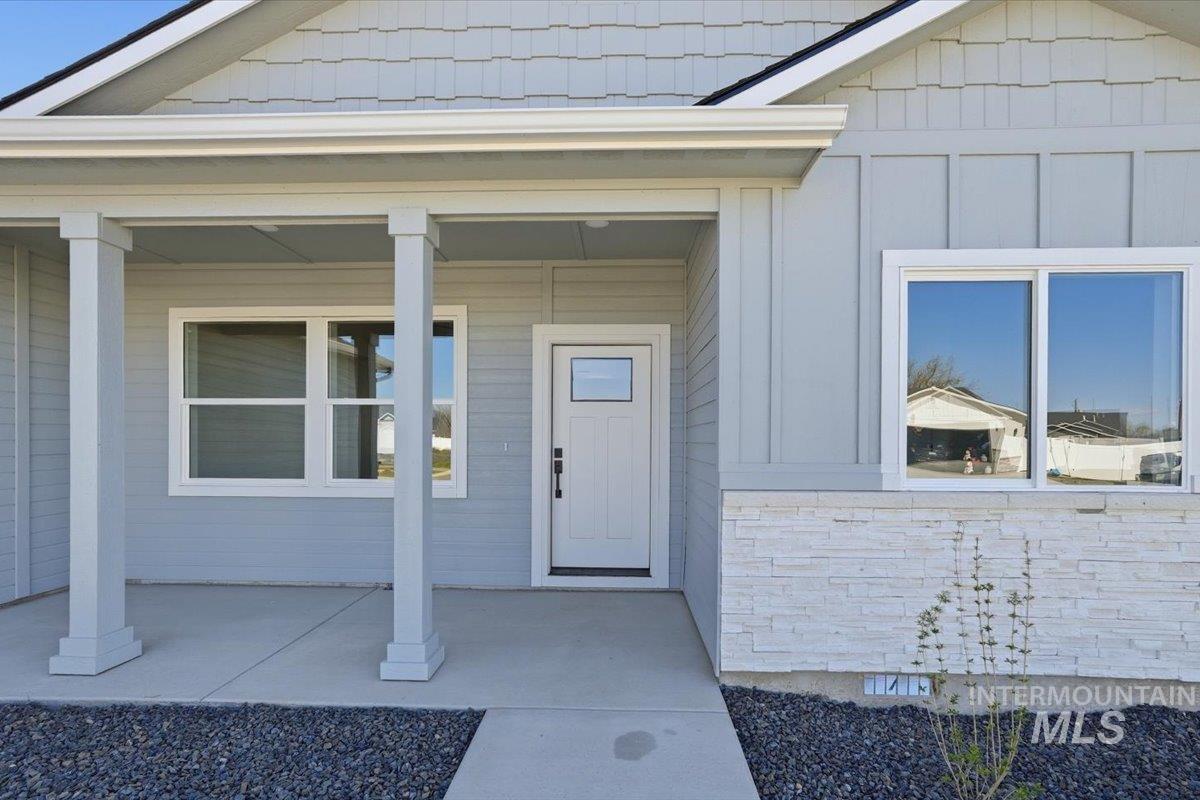 2173 Austin Way Fruitland, ID 83619 - Photo 2 of 28 View of exterior entry with covered porch and board and batten siding