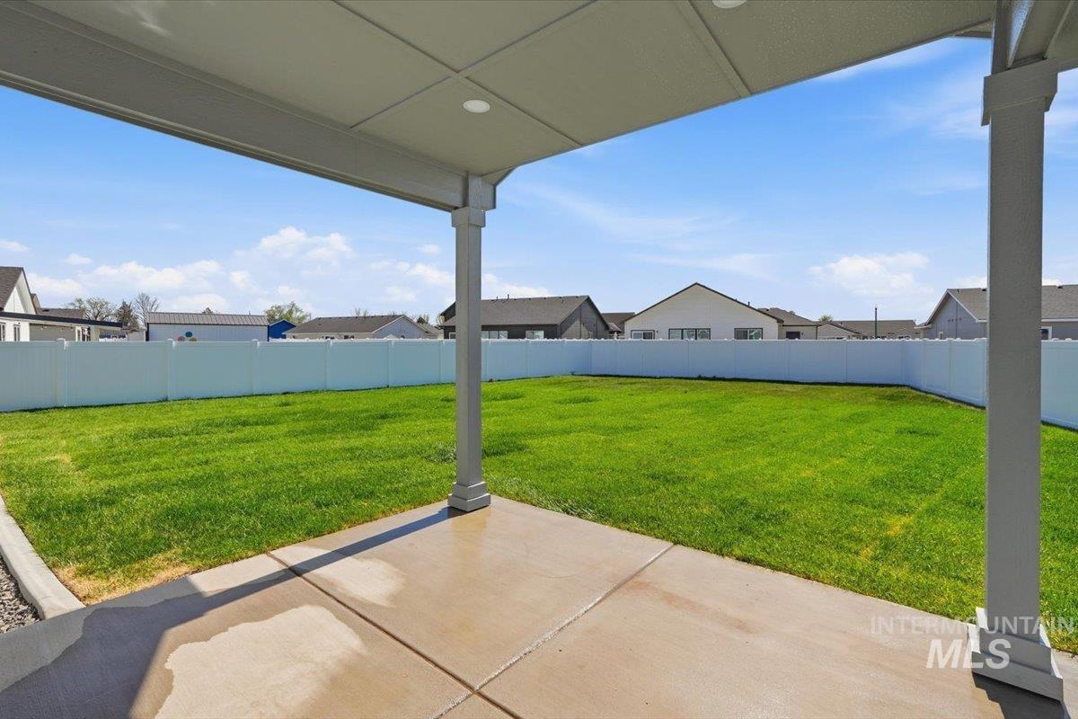 2173 Austin Way Fruitland, ID 83619 - Photo 23 of 28 Fenced backyard with a patio and a residential view