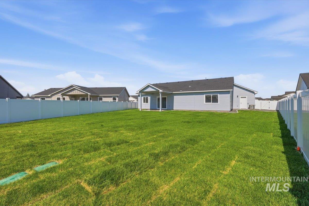 2173 Austin Way Fruitland, ID 83619 - Photo 24 of 28 Rear view of property featuring a fenced backyard and a patio area