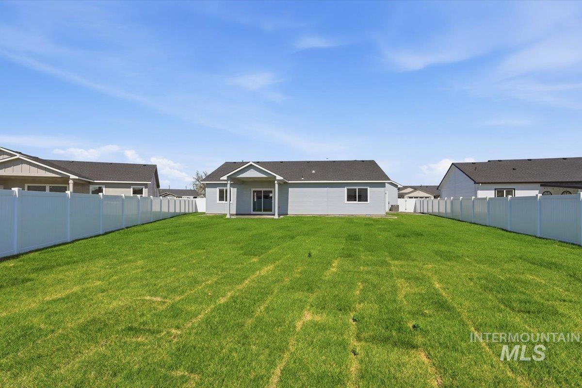 2173 Austin Way Fruitland, ID 83619 - Photo 25 of 28 Rear view of property with a fenced backyard and a patio