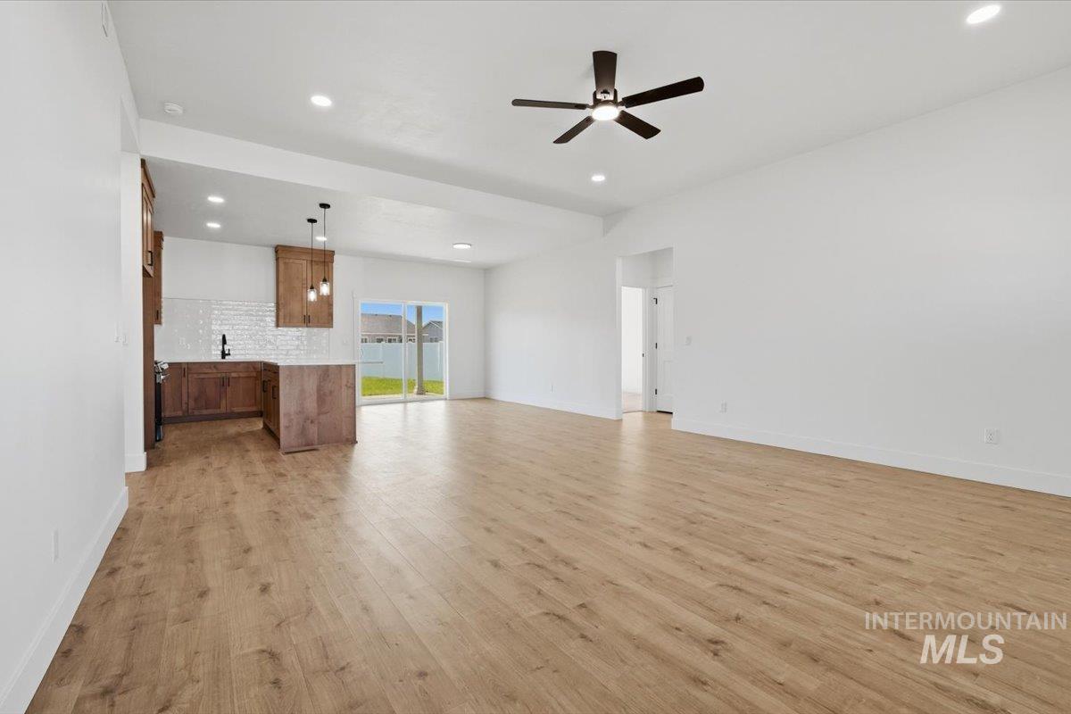 2173 Austin Way Fruitland, ID 83619 - Photo 7 of 28 Unfurnished living room with light wood finished floors, a ceiling fan, and recessed lighting