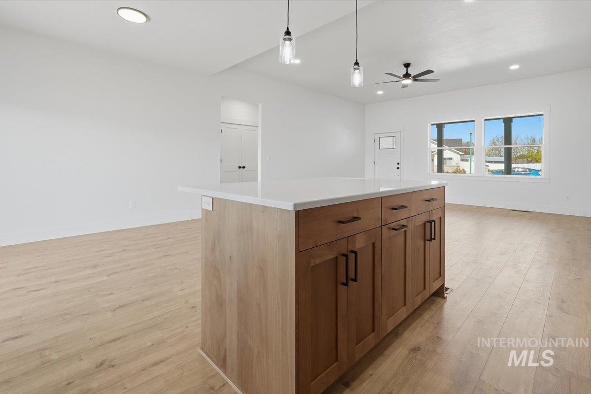 2173 Austin Way Fruitland, ID 83619 - Photo 28 of 28 Kitchen with pendant lighting, light wood-style floors, a center island, and open floor plan