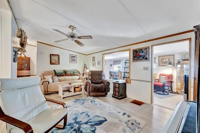 a living room with furniture ceiling fan and a rug