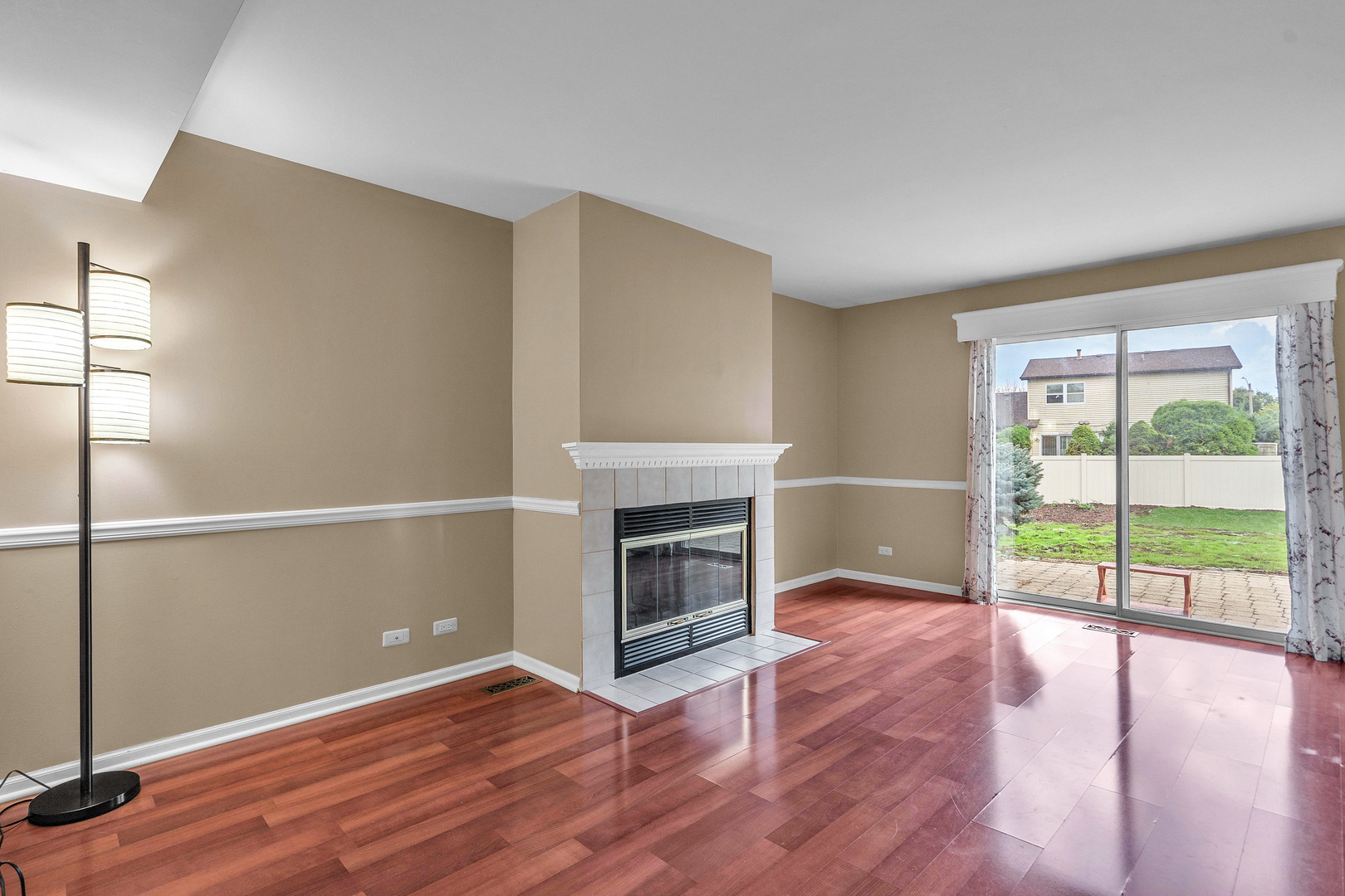 681 Legends Drive Carol Stream, IL 60188 - Photo 19 of 34 an empty room with wooden floor fireplace and windows