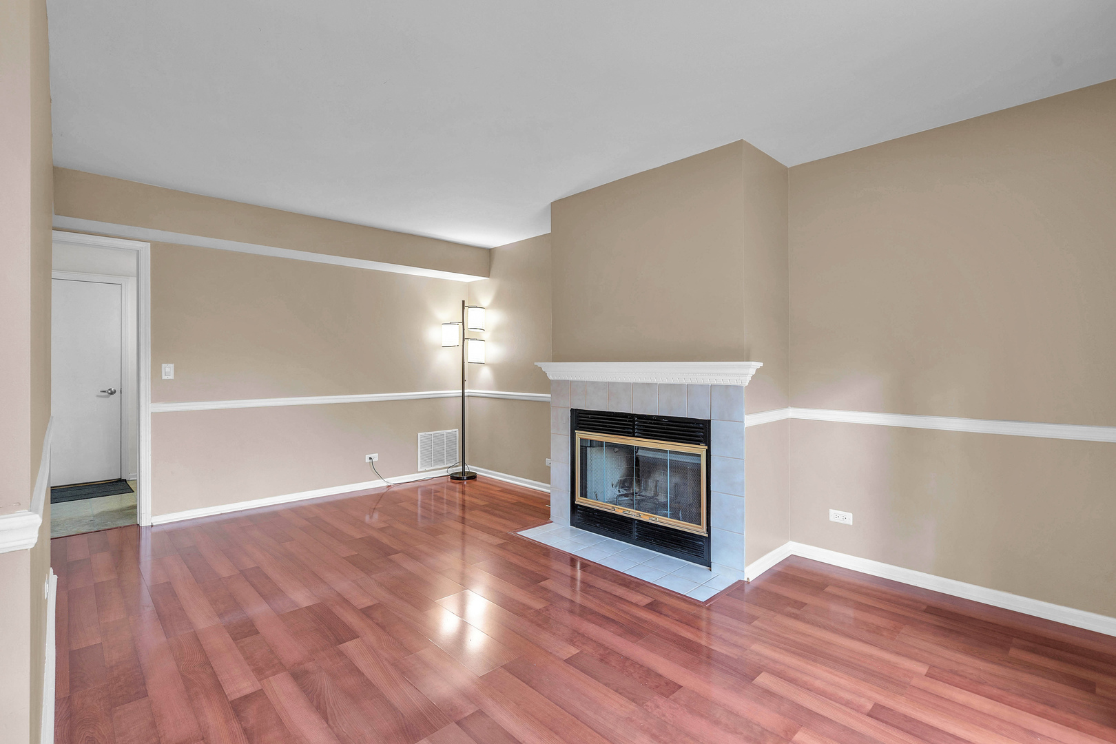 681 Legends Drive Carol Stream, IL 60188 - Photo 20 of 34 a view of an empty room with wooden floor fire place and a window