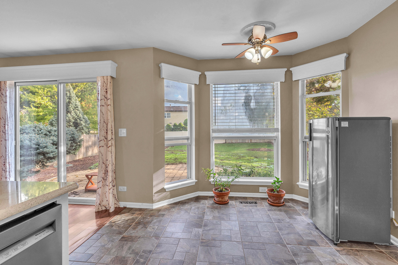 681 Legends Drive Carol Stream, IL 60188 - Photo 25 of 34 a view of a room with a large window and a kitchen