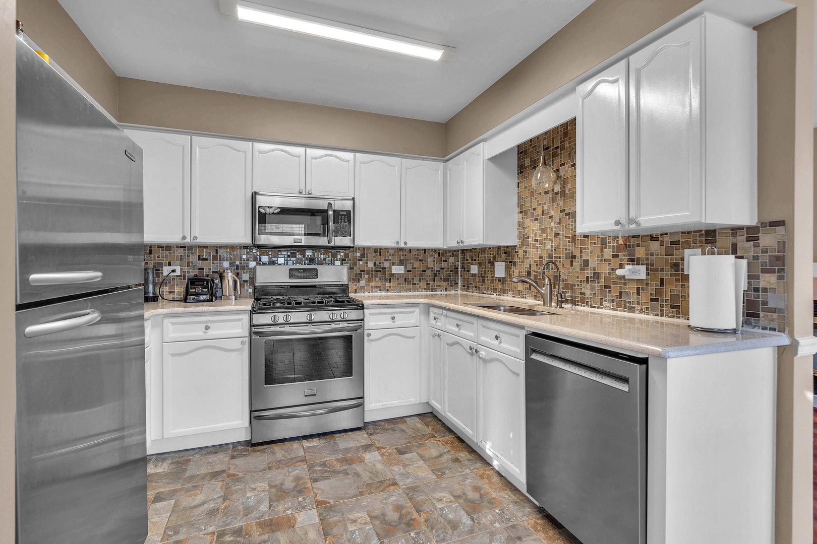 681 Legends Drive Carol Stream, IL 60188 - Photo 26 of 34 a kitchen with cabinets appliances a sink and a stove