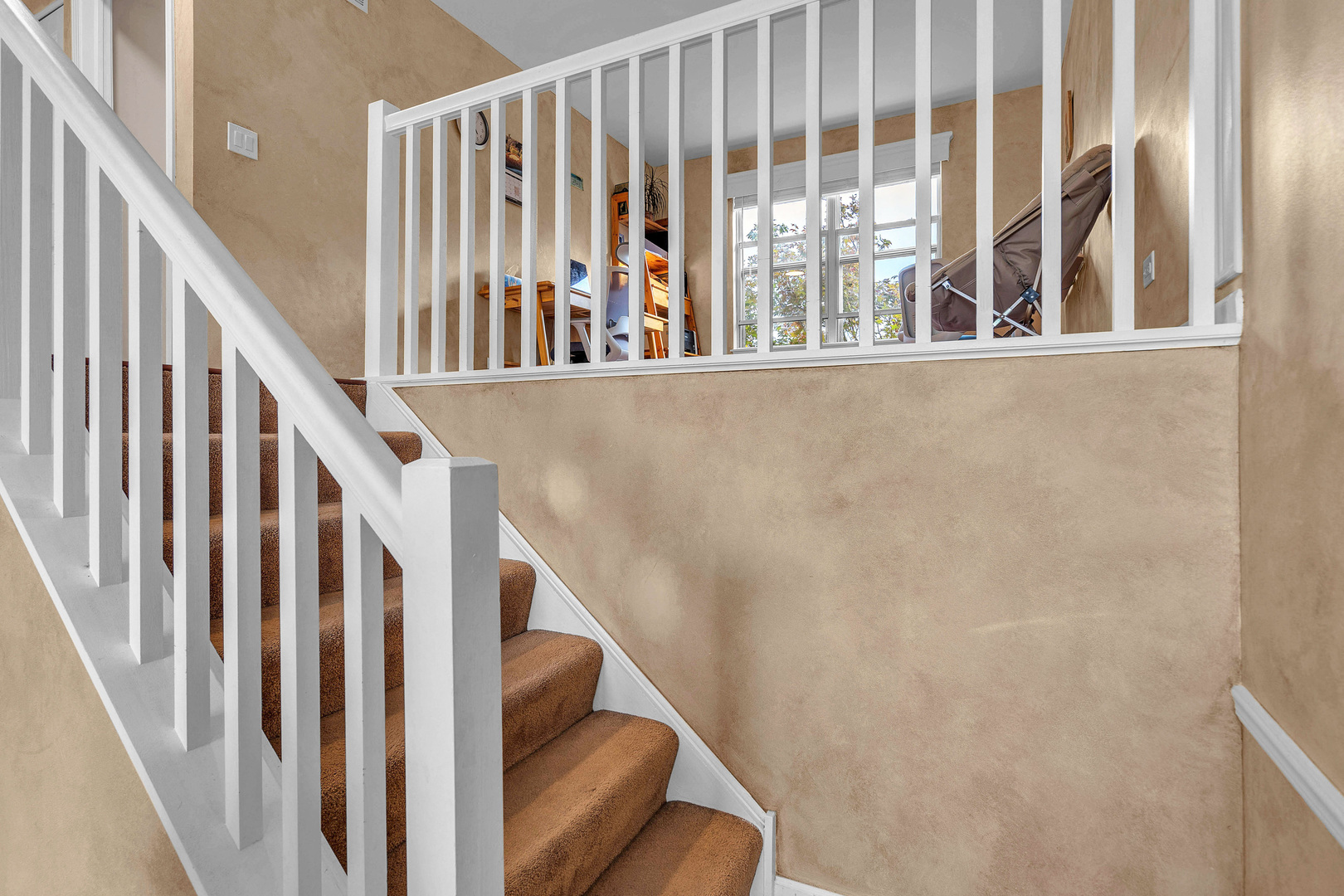 681 Legends Drive Carol Stream, IL 60188 - Photo 8 of 34 a view of staircase with lots of frames on wall and a window