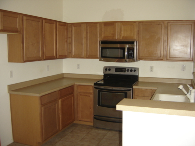 44217 Roth Road Maricopa, AZ 85138 - Photo 4 of 10 a kitchen with a sink and a microwave