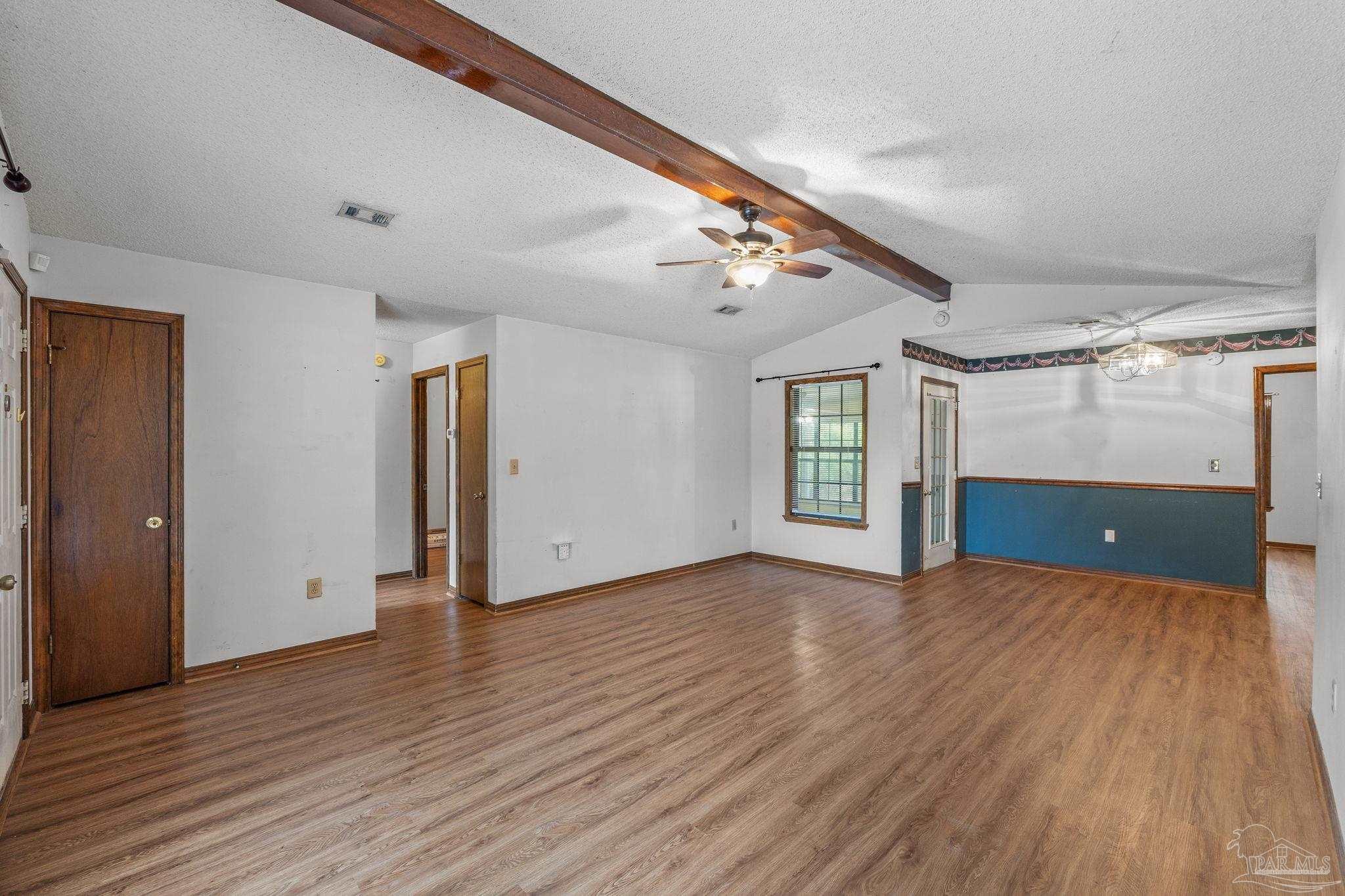 426 Brown Place Crestview, FL 32539 - Photo 11 of 40 a view of an empty room with window and wooden floor
