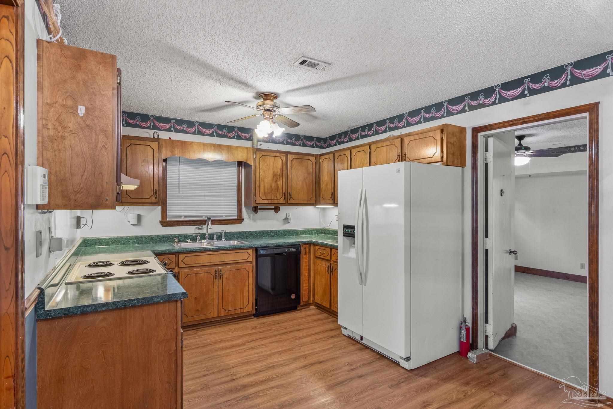 426 Brown Place Crestview, FL 32539 - Photo 14 of 40 a kitchen with stainless steel appliances granite countertop a refrigerator a sink and a stove