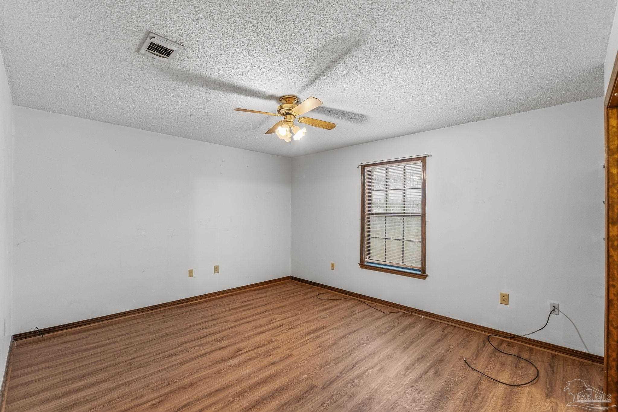 426 Brown Place Crestview, FL 32539 - Photo 22 of 40 wooden floor in an empty room with a window
