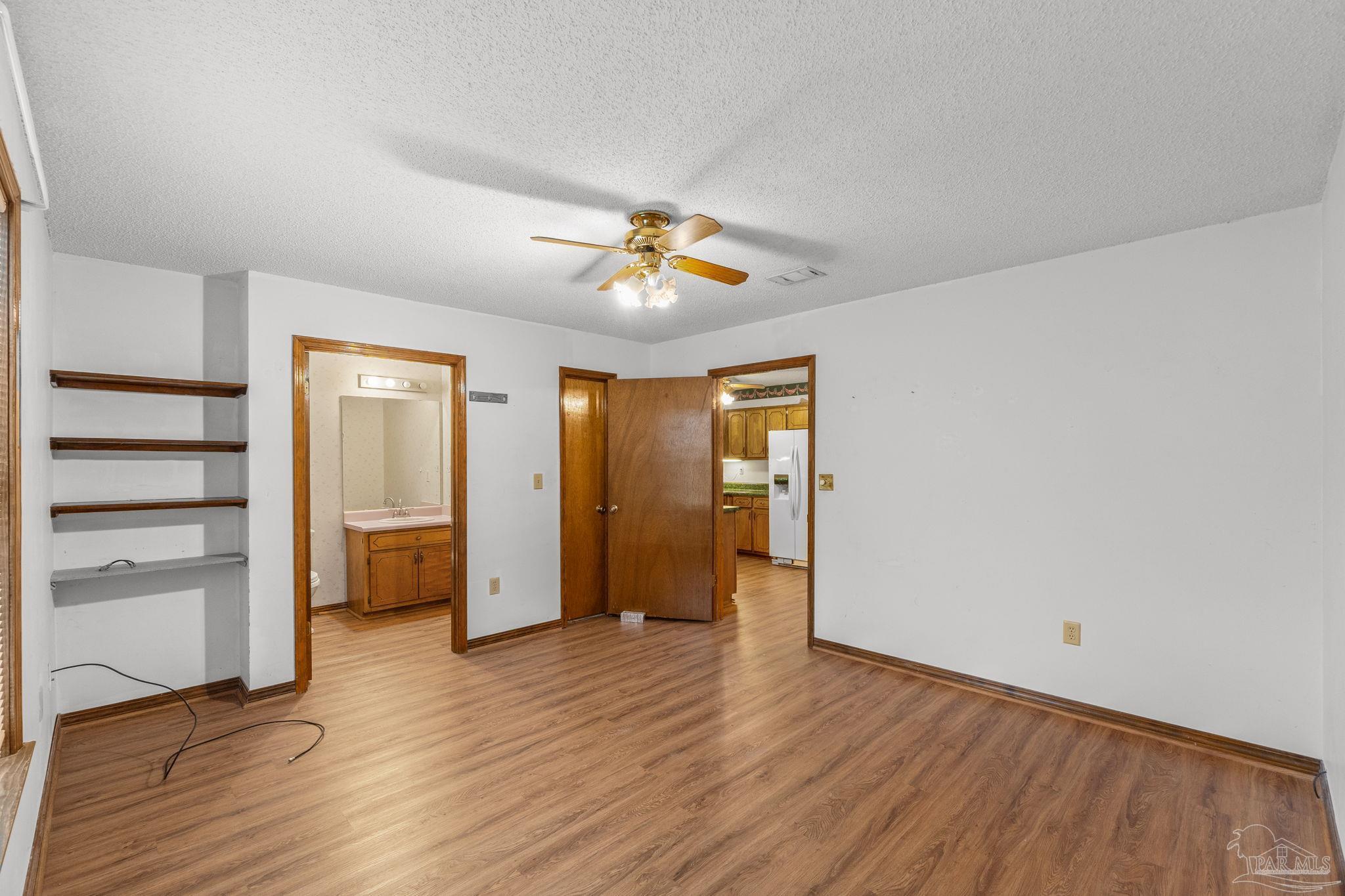 426 Brown Place Crestview, FL 32539 - Photo 23 of 40 a view of empty room with wooden floor
