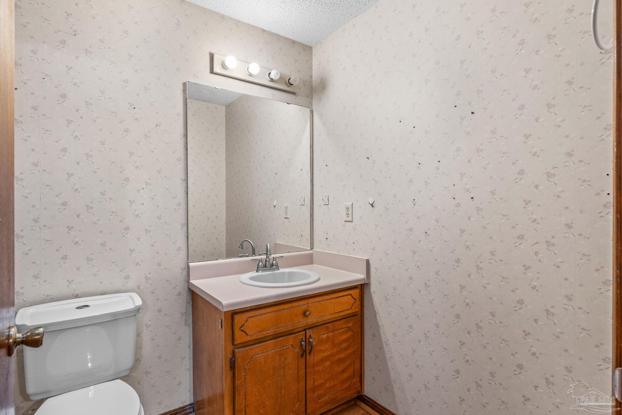 426 Brown Place Crestview, FL 32539 - Photo 25 of 40 a bathroom with a sink a toilet and mirror