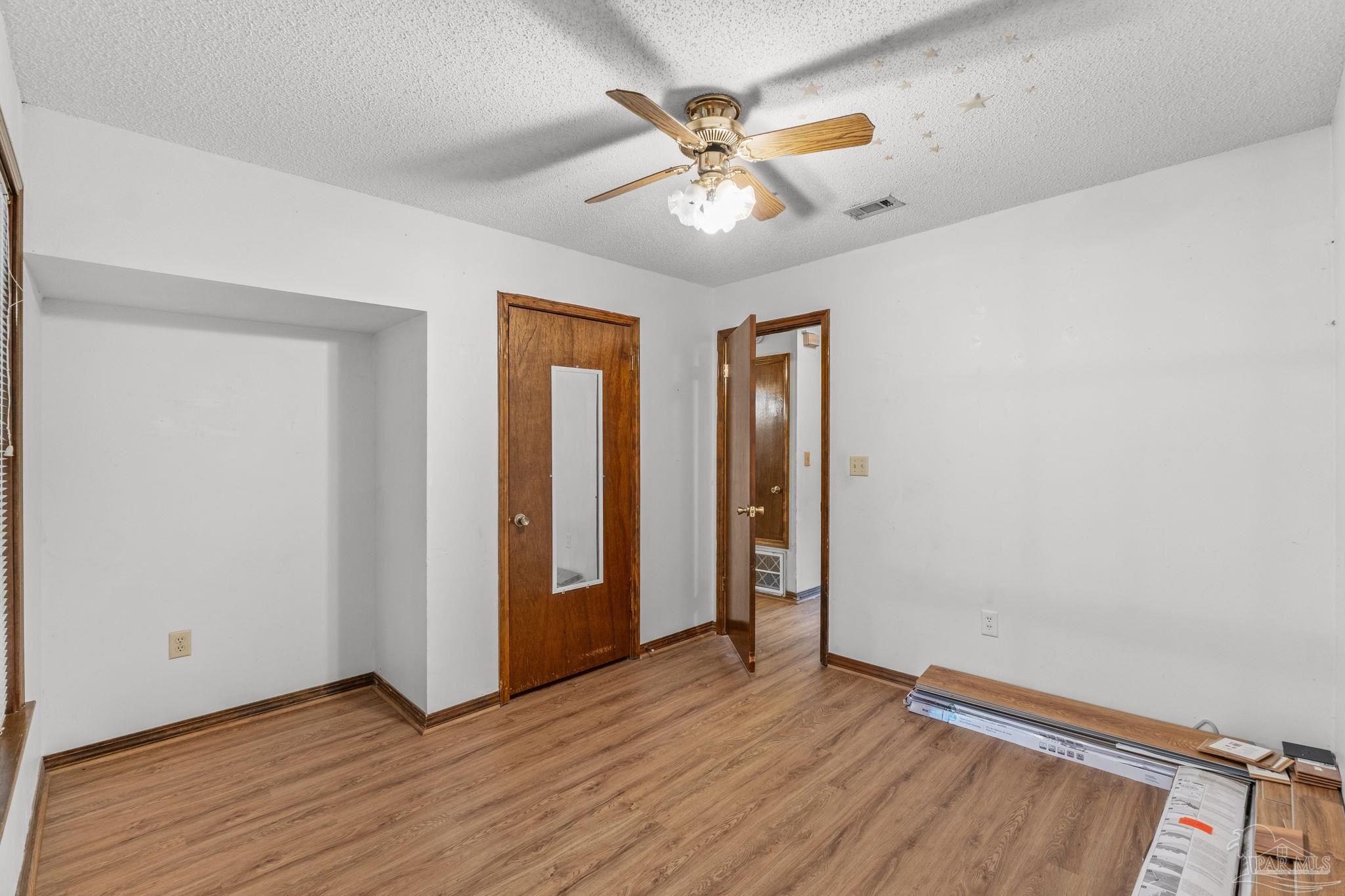 426 Brown Place Crestview, FL 32539 - Photo 29 of 40 wooden floor in an empty room with a window