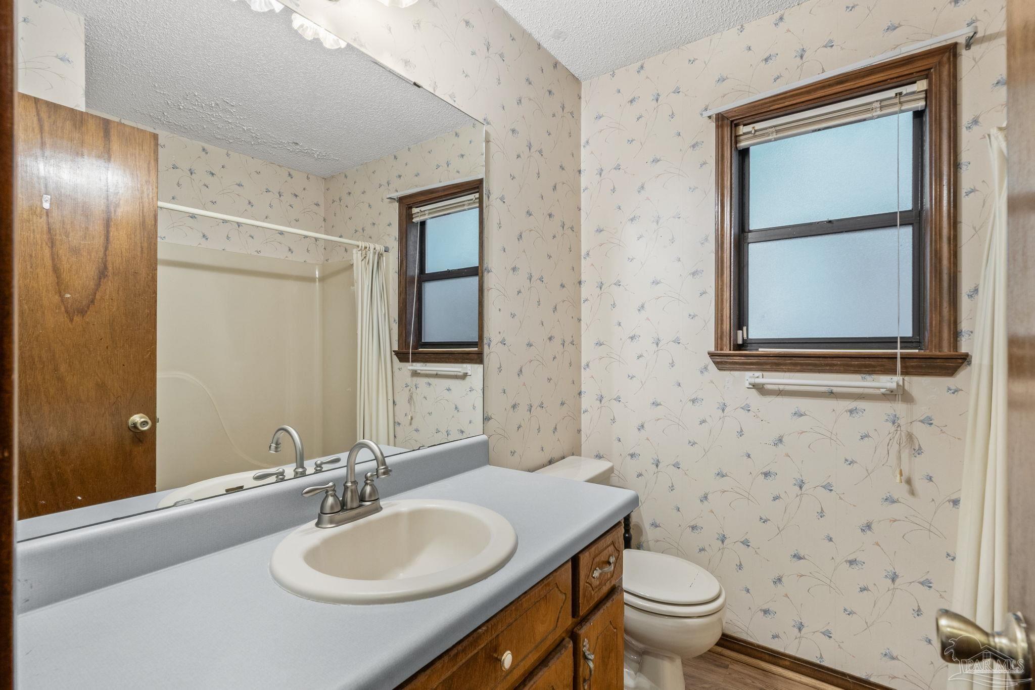426 Brown Place Crestview, FL 32539 - Photo 32 of 40 a bathroom with a toilet sink and mirror