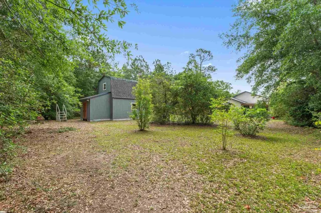 a backyard of a house with lots of green space