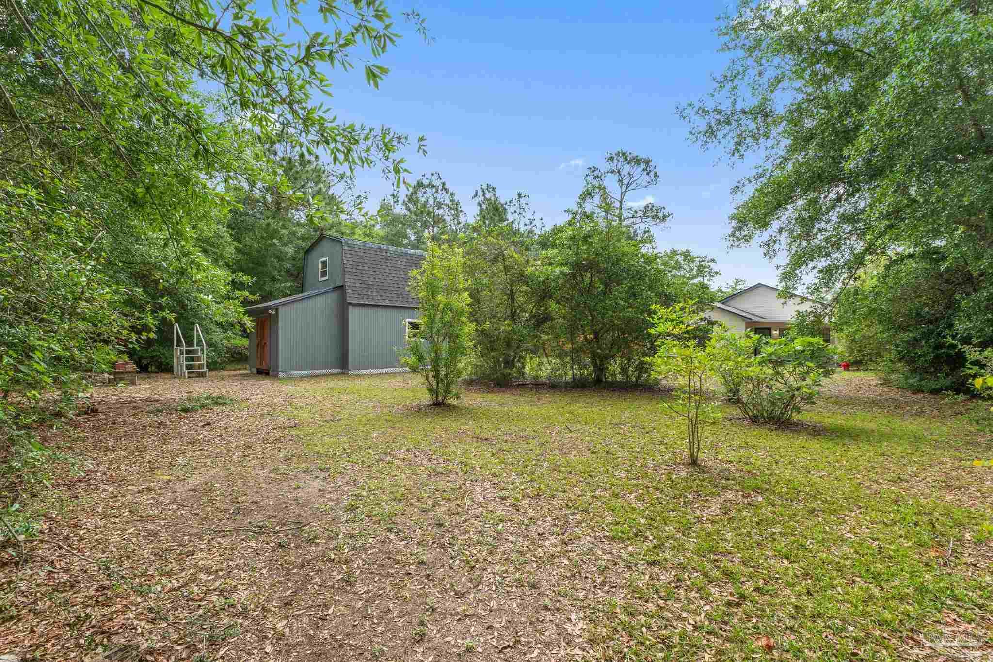 426 Brown Place Crestview, FL 32539 - Photo 40 of 40 a backyard of a house with lots of green space