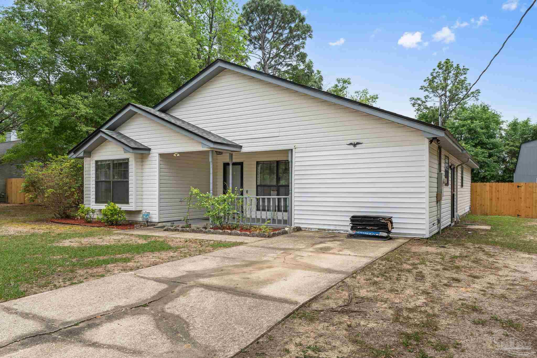 426 Brown Place Crestview, FL 32539 - Photo 5 of 40 a view of a house with a yard and potted plants
