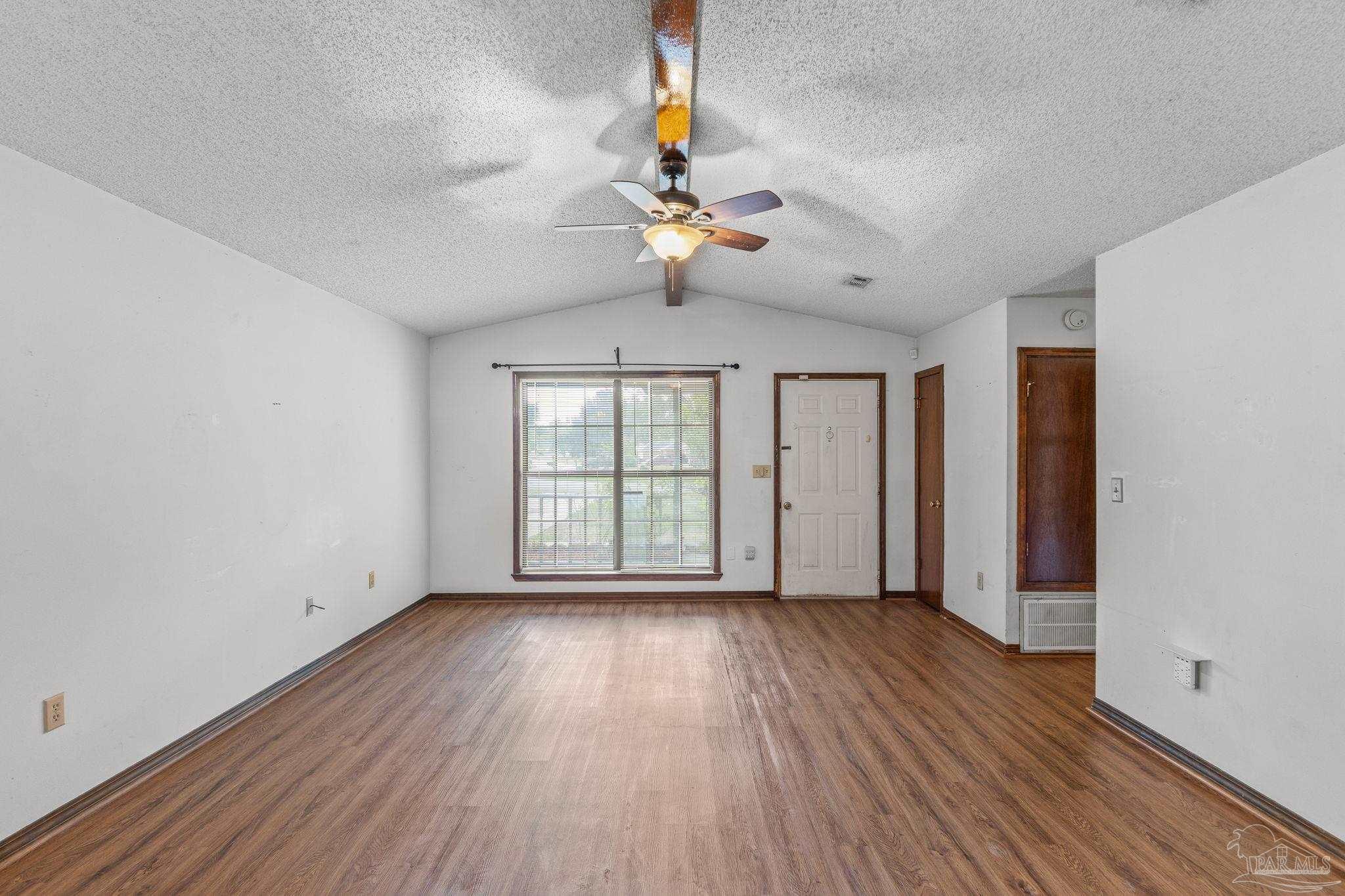 426 Brown Place Crestview, FL 32539 - Photo 9 of 40 wooden floor in an empty room with a window