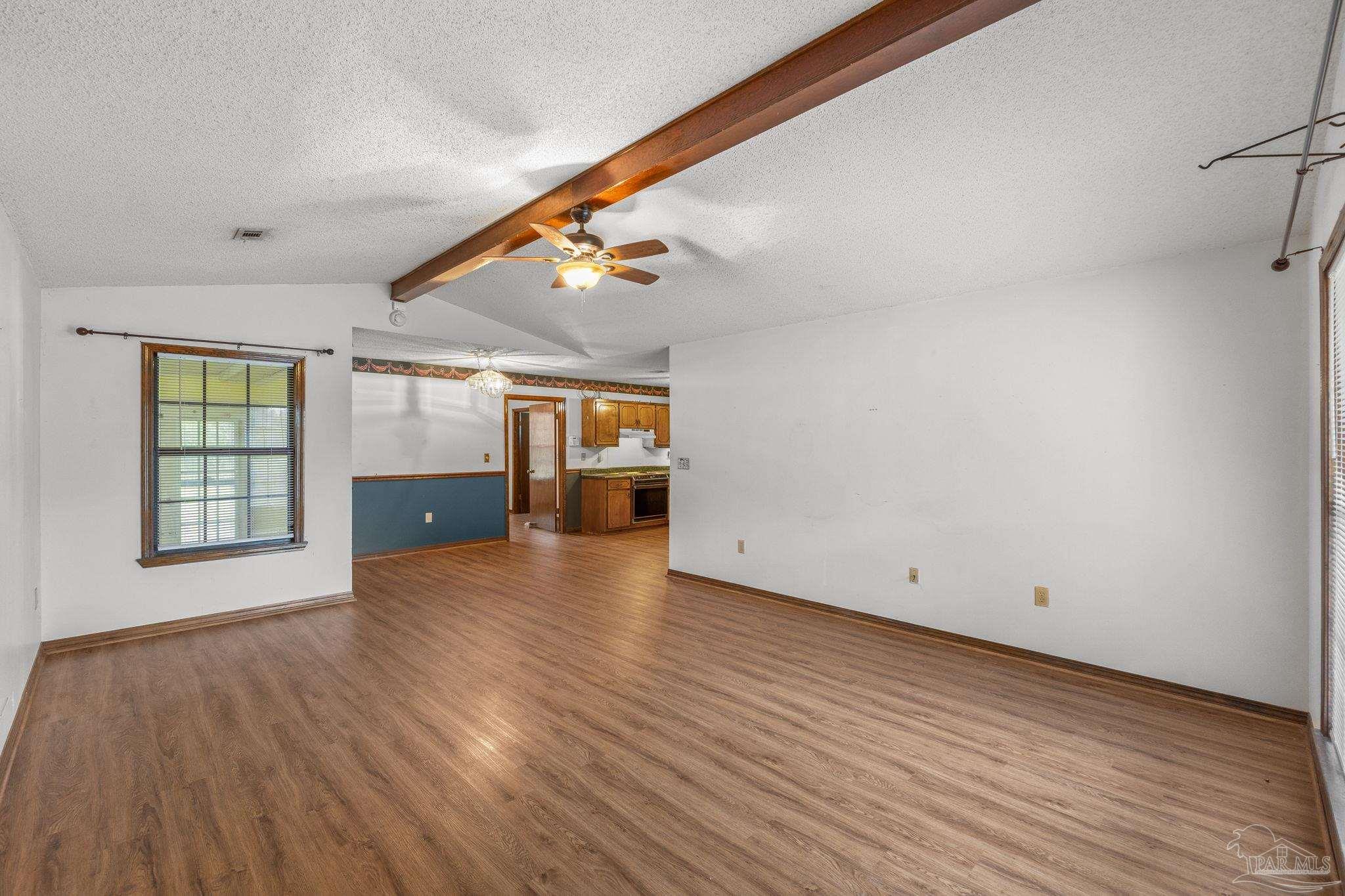 426 Brown Place Crestview, FL 32539 - Photo 10 of 40 a view of empty room with wooden floor and fan