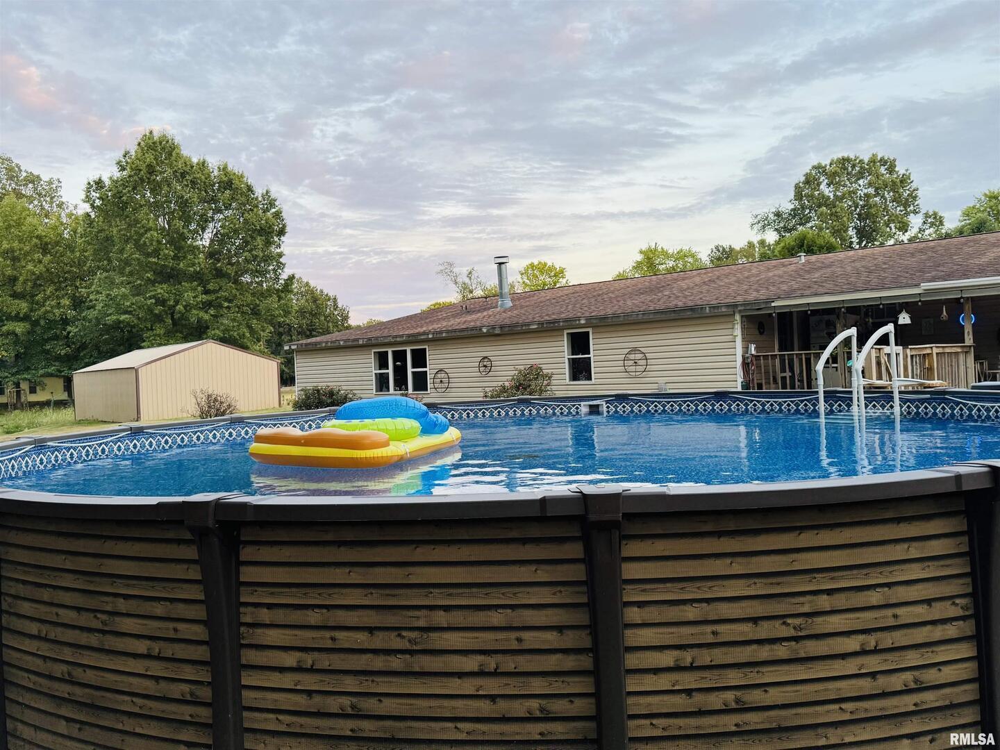 3920 Herrin Road Carterville, IL 62918 - Photo 25 of 34 a view of swimming pool with a patio and a yard