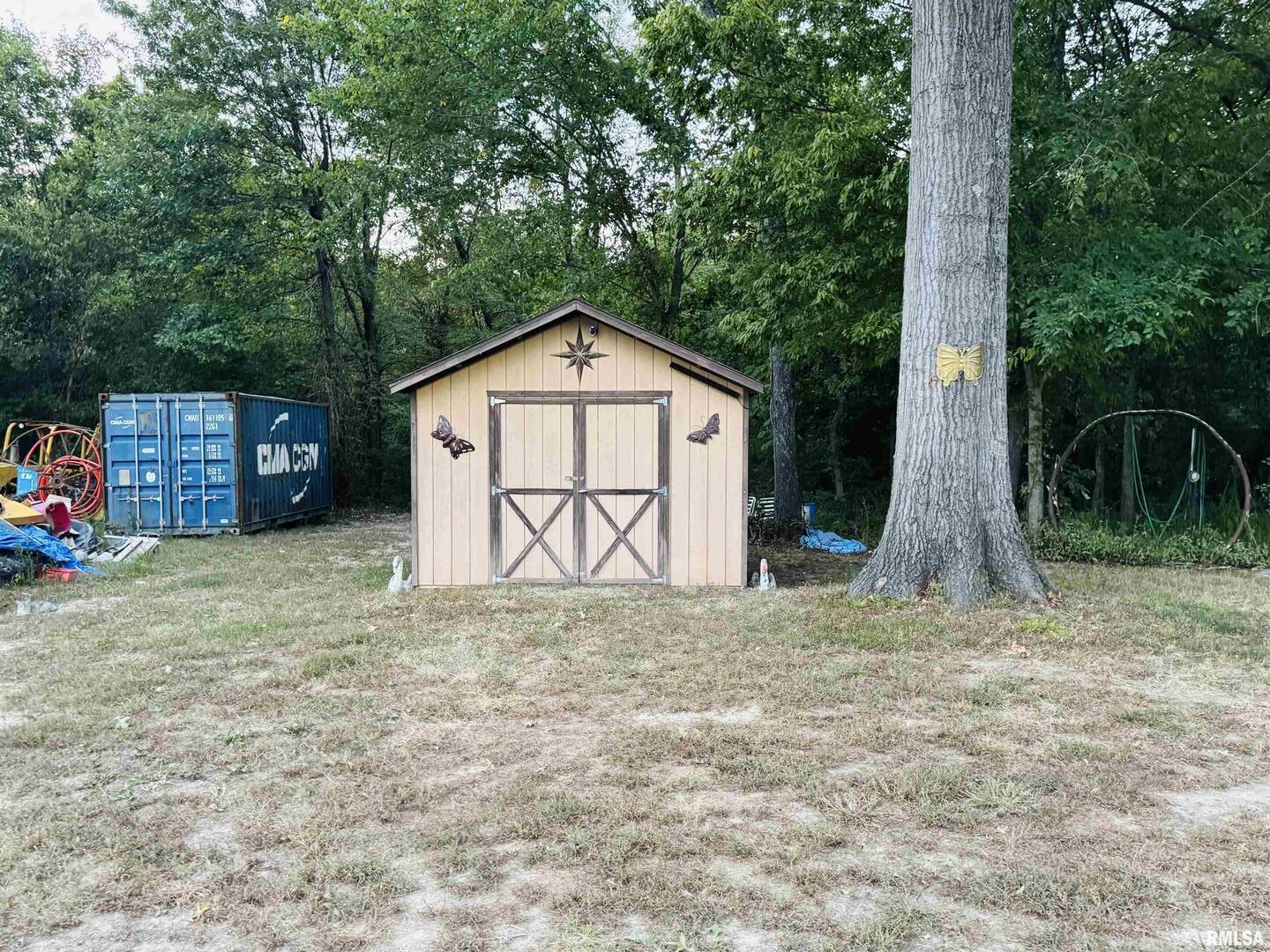 3920 Herrin Road Carterville, IL 62918 - Photo 31 of 34 a view of a wooden house with a yard and large trees