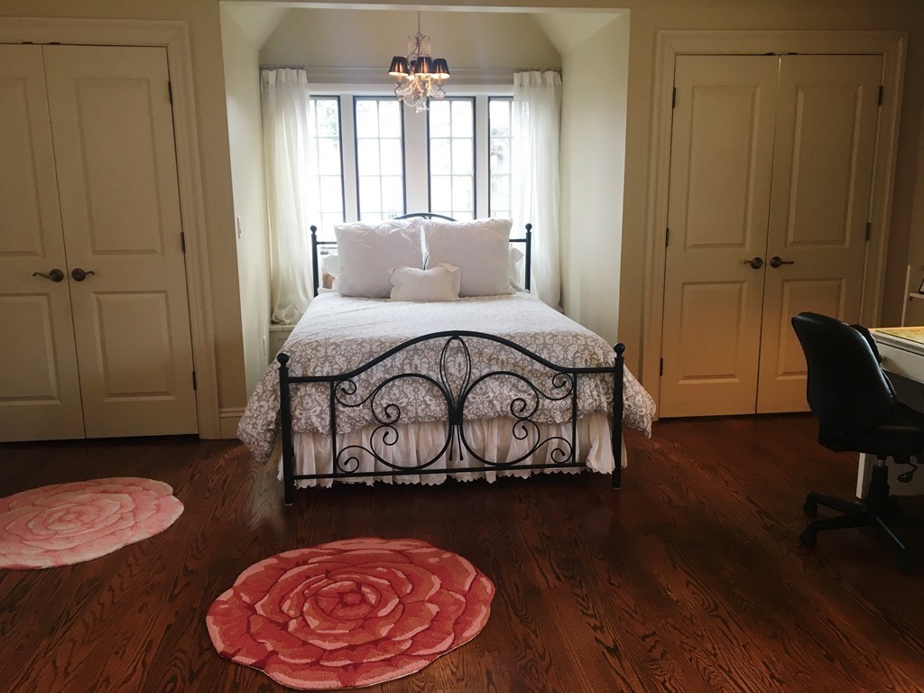77 Cliff Road Wellesley, MA 02481 - Photo 15 of 29 a bedroom with a bed and a chair