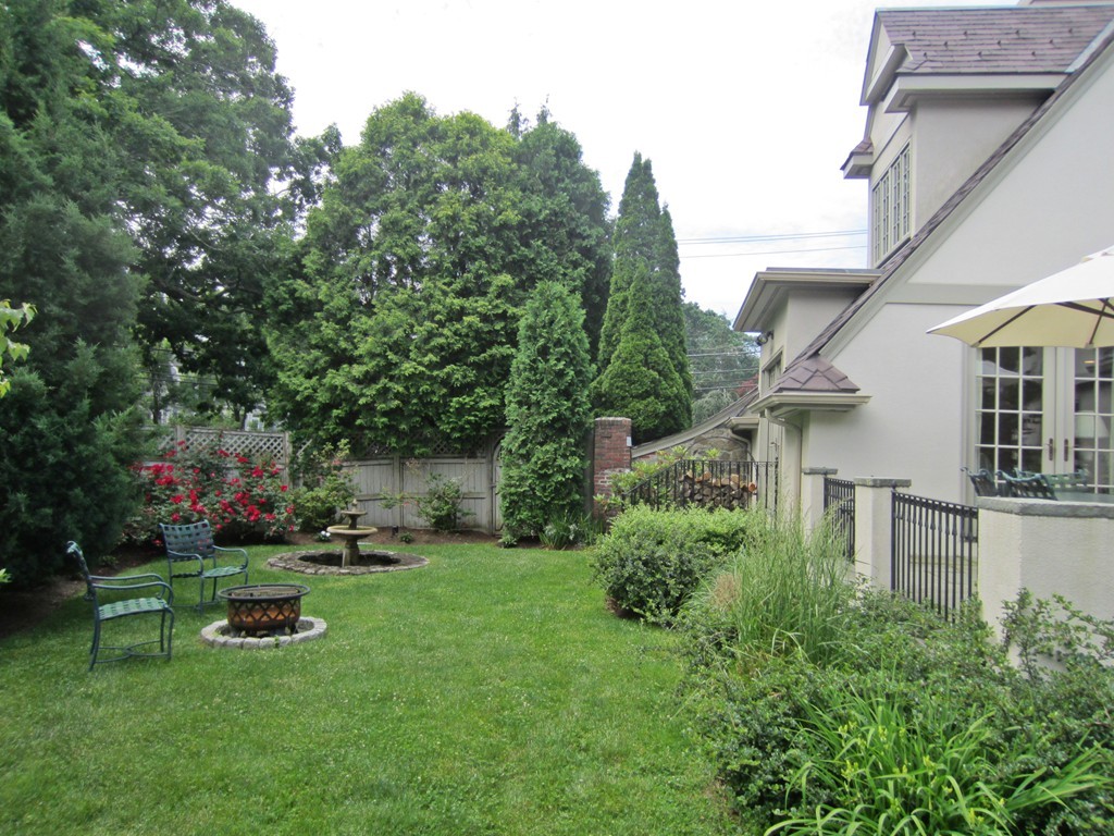 77 Cliff Road Wellesley, MA 02481 - Photo 25 of 29 a view of backyard with swimming pool and green space