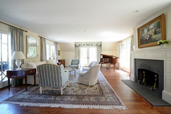 77 Cliff Road Wellesley, MA 02481 - Photo 5 of 29 a living room with furniture a rug and a fireplace
