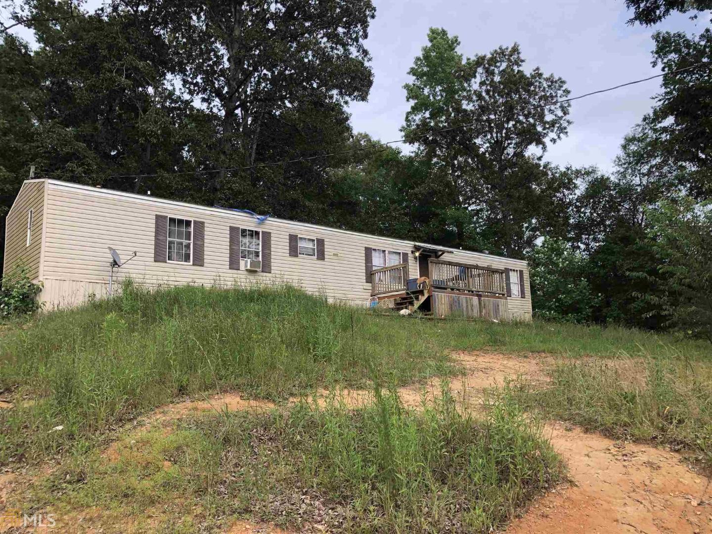 1104 Kesler Road Carnesville, GA 30521 - Photo 1 of 1 a backyard of a house with a garden and deck