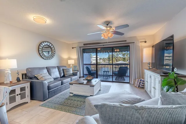 a living room with furniture potted plant and a window