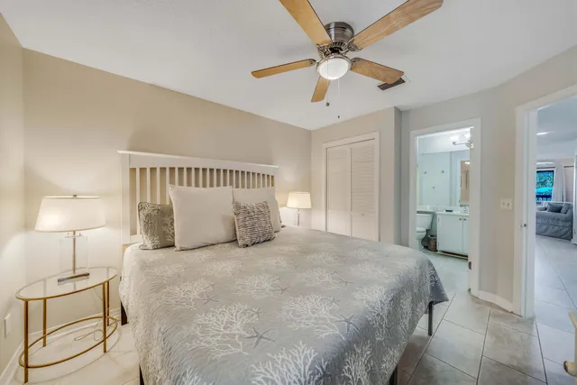 a spacious bedroom with a bed and a lamp