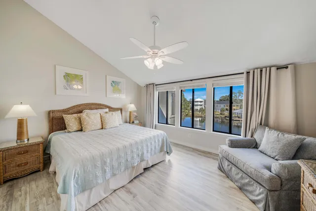 a bedroom with a large bed couch and a window