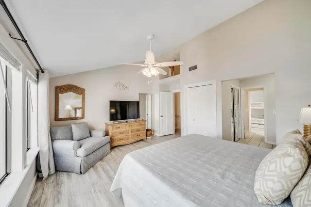 a bedroom with a large bed and a couch