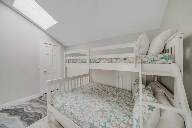 a view of a bedroom with a bed and chair