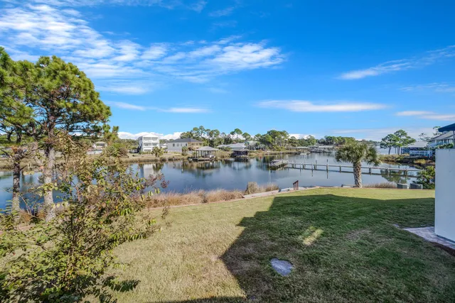 a view of a lake with houses in the back