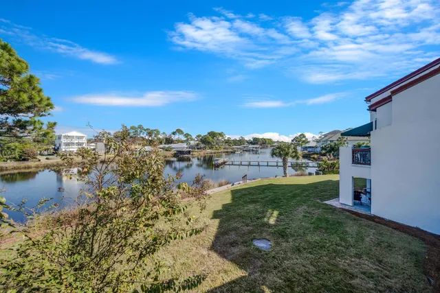 a view of a lake with houses in the back