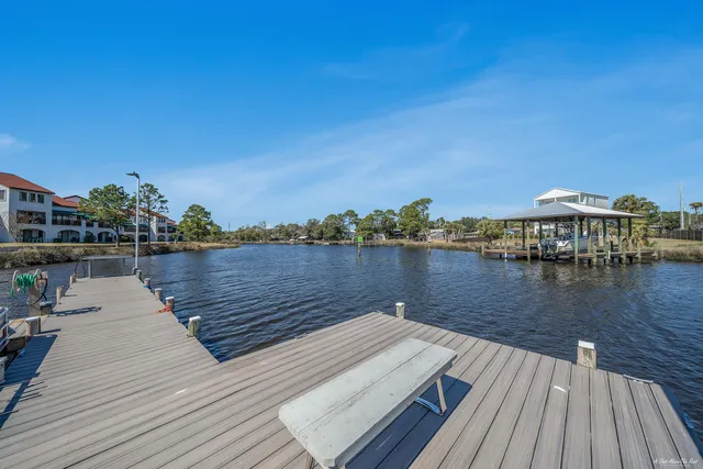a view of a lake with boats and trees in the background