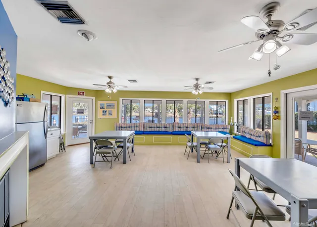 a view of a dining room with furniture a chandelier and wooden floor