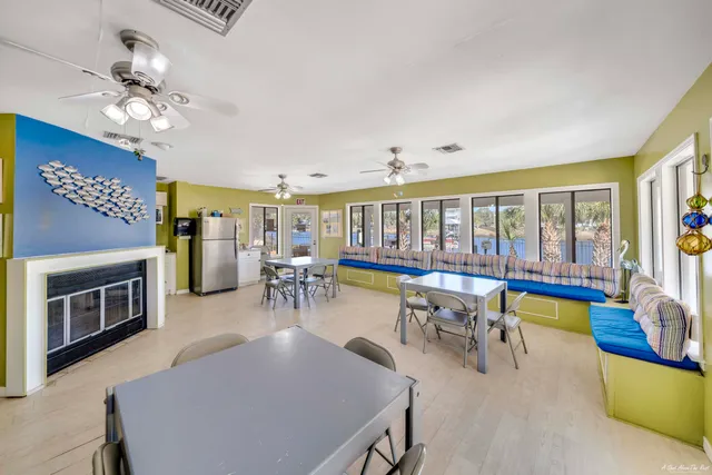 a view of a dining room with furniture a chandelier and wooden floor